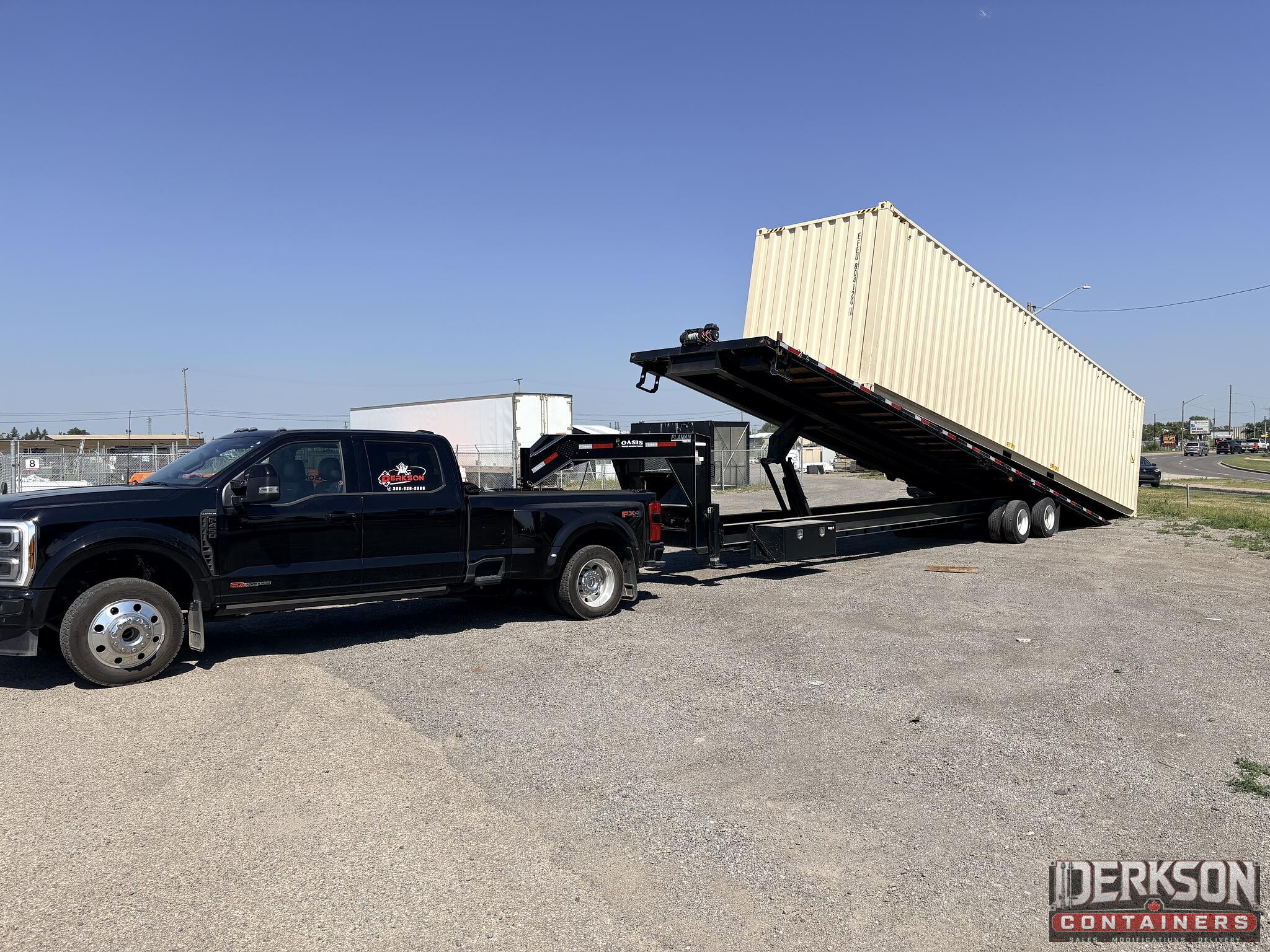 Derkson Containers tilt-deck delivery truck unloading a container